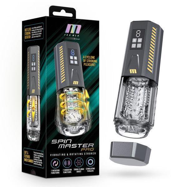 A sleek black box featuring an image of the Spin Master Pro Vibrating, Stroking, Rotating, Automatic Stroker from Blush is displayed. Next to the box sits the masturbator device, highlighting its clear textured chamber, various vibration settings, and a digital screen on its handle. The removed cap rests beside it.