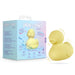 The Splash Waterproof Rubber Duckie Vibrator, shaped like a yellow duck, is shown beside its light blue box with playful designs and text reading "play with me by blush" and "SPLASH." Illustrated lines emphasize the duckie's vibrating motion.