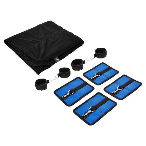 The image features the Sportsheets "Sportsheet The Original Bed Bondage Sheet - King Size" in black nylon, folded next to four blue rectangular pieces equipped with black straps and silver clips, along with four black wrist or ankle cuffs that also have silver clips. All items are carefully arranged on a plain white background, indicating their purpose for bondage activities.
