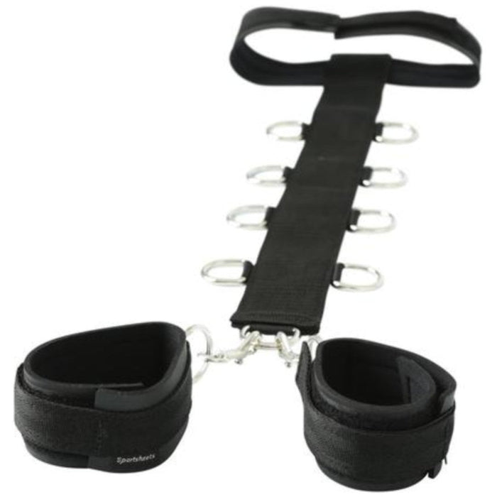 Adjustable black ankle cuffs with multiple metal d-rings and a central nylon webbing restraint strap designed for resistance training or exercise using the Sportsheets Neck and Wrist Restraint by Sportsheets.