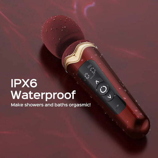 A maroon Stormi Powerful Heating Wand Vibrator with Charging Case by Honey Play Box is displayed against a matching maroon background. The text "IPX6 Waterproof. Make showers and baths orgasmic!" is in white on the left side. Water droplets are visible on the massager, and its elegant power offers versatile vibration patterns, emphasizing its waterproof feature.