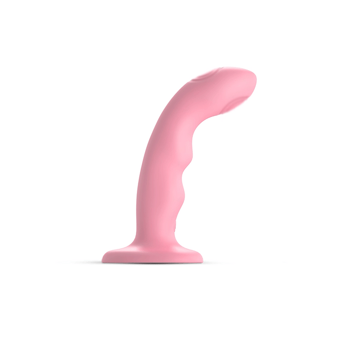 The Strap on Me G-Spot Tapping Silicone Dildo from Lovely Planet, in pink, features a curved shape and smooth surface. It stands upright against a plain white background, showcasing its suction base. The toy also has several ridges along its length designed for enhanced g-spot stimulation.