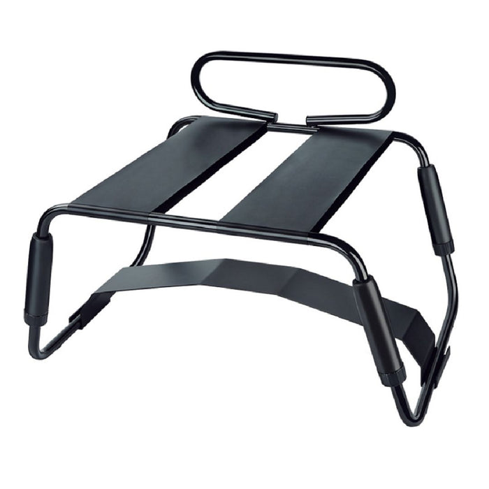 A black Surrender Sex Chair with 8 Inch Vibrating Dildo from blush with an adjustable lifting system designed for improved posture. It has two smooth, inclined platforms for foot placement and metal frame support with padded corners for stability and comfort.