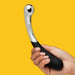 A hand holds the Sweet Pressure Metal & Silicone Double Ended Dildo, featuring a curved silver and black design with a shiny stainless steel end for temperature play, set against a solid yellow background.