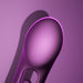 A close-up of the Tempo G-Spot Tapping Pressure Sensing App-Controlled Vibrator, featuring a smooth, purple, oval shape with a matte finish, is set against a matching purple background and soft shadow.