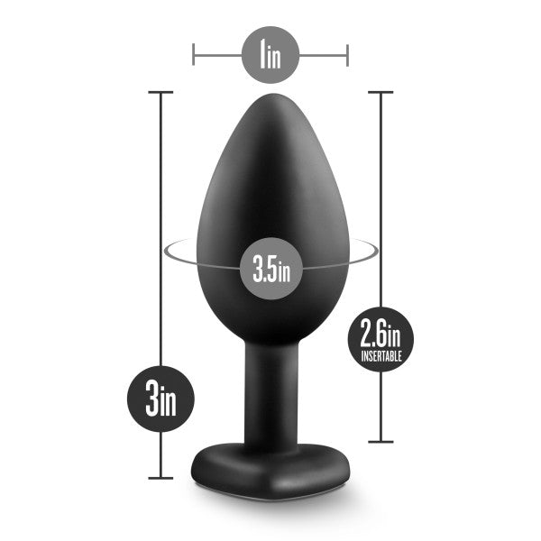 The Temptasia Bling Small Silicone Butt Plug by Blush is a black, satin smooth silicone plug featuring a heart-shaped base for safety. It measures 3 inches in height, 1 inch in width at the narrowest part, 3.5 inches at the widest part, and has an insertable length of 2.6 inches. This elegantly tapered bling plug effortlessly combines comfort and style.