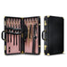 Two leather-bound cases from the Temptasia Safe Word Bondage Kit by Blush are shown. The left case is open, revealing various BDSM accessories including cuffs, collars, chains, paddles, and a gag—perfect for both beginners and intermediate players. The right case is closed, showcasing its exterior. Both have gold accents, handles, and lock mechanisms.