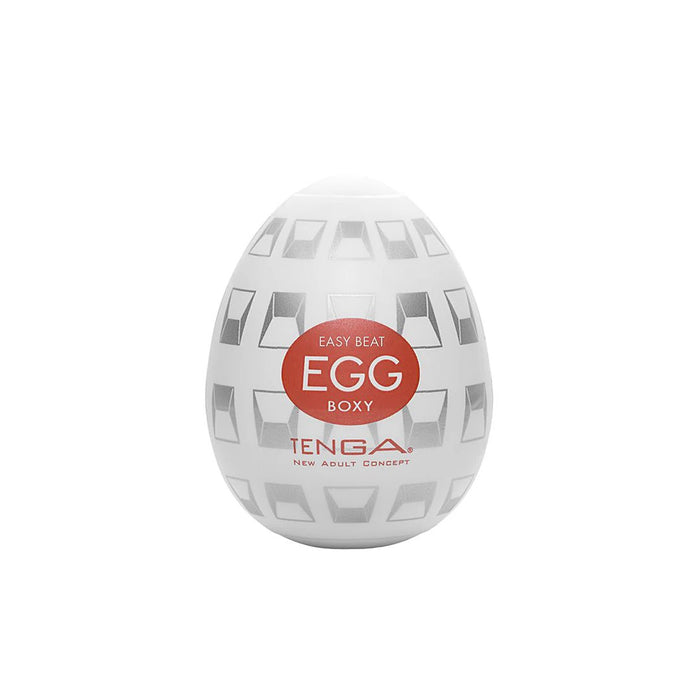 A white, egg-shaped container with a geometric pattern and a red label in the center. The label reads "TENGA EGG DISPOSABLE PENIS MASTURBATOR - BOXY" with the brand name "TENGA" and the words "NEW ADULT CONCEPT" below. This Tenga Egg Disposable Penis Masturbator - Boxy is your perfect travel buddy, offering a convenient disposable masturbation sleeve for on-the-go pleasure.
