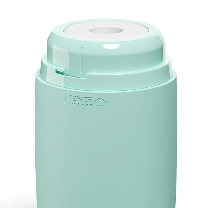 A Tenga Puffy Discreet Ultra Soft Beaded Masturbator - Mint Green with white accents, featuring the brand name "TENGA" engraved on the side along with the text "New Adult Concept." The top section has a white circular opening, suggesting it could be a device or container. Made from ultra-soft spongy material, it's easy to clean and maintain.