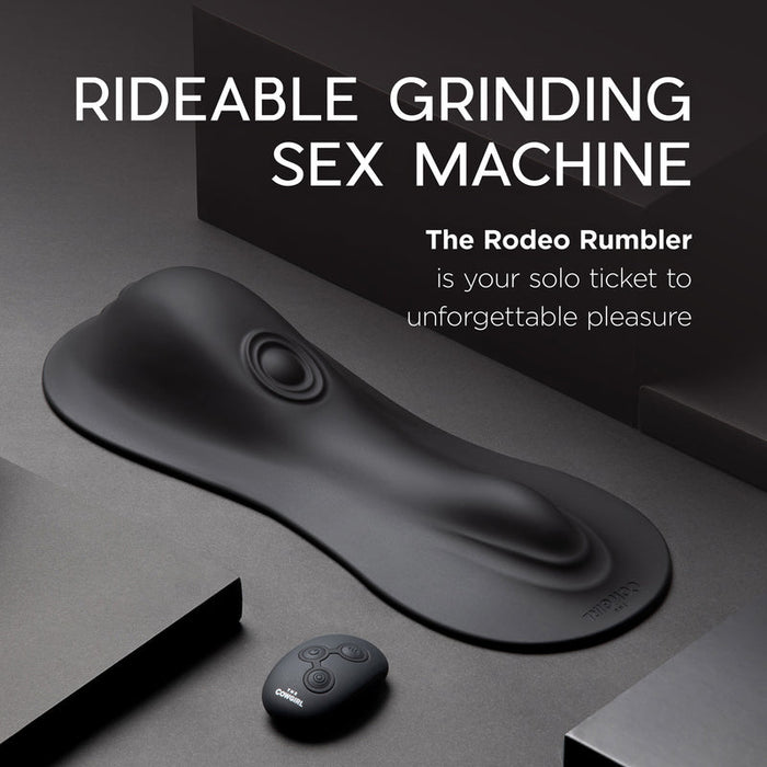 The Cowgirl Rodeo Rumbler Grinding Sex Machine in sleek black is shown with a wireless remote. Minimalist dark background sets the scene for this rideable pleasure machine, promising solo hands-free stimulation and unforgettable thrills.