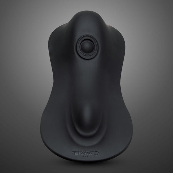 The Cowgirl Rodeo Rumbler Grinding Sex Machine is a sleek black silicone device with a contoured shape and circular top opening, shown on a gray gradient background. “Cowgirl” is embossed near the base—ideal for hands-free stimulation.