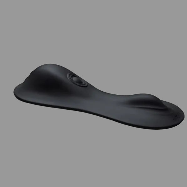 The Cowgirl Rodeo Rumbler Grinding Sex Machine’s black ergonomic wrist rest, with a contoured design and raised sections for hand and wrist support, is inspired by rideable pleasure machines and shown on a plain gray background.