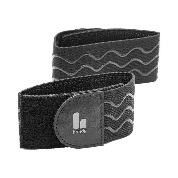 Two black Handy TrueGrip Pro Band straps with Velcro closures, wavy anti-slip silicone grips, and a small "handy" logo on a rectangular patch, coiled and displayed against a white background.
