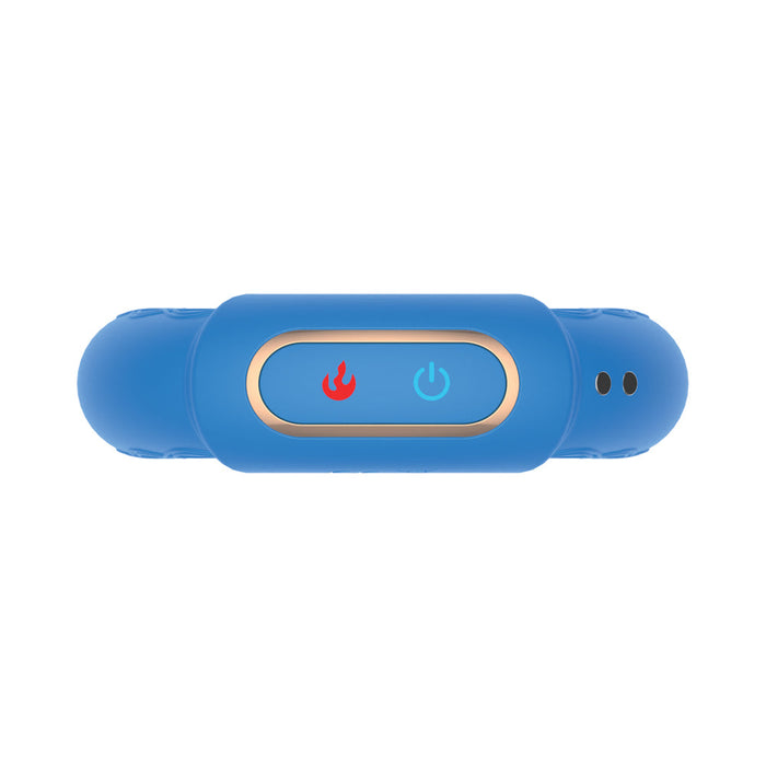 The Royale Warming Vibrating Cock Ring for Couples—blue, cylindrical, with a gold-bordered panel featuring a red flame icon and blue power button—photographed from above on a white background.