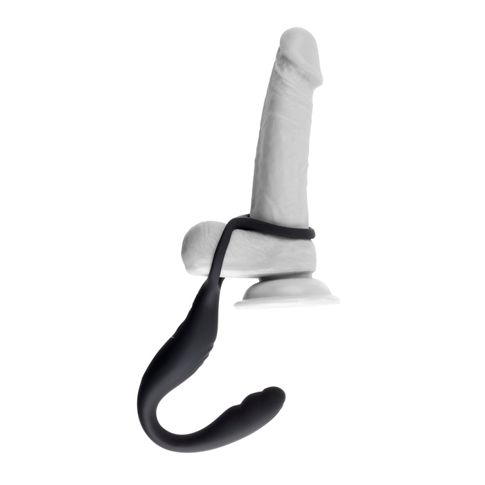 A black harness with a curved extension from the Evolved Novelties product line, featuring ribbed sections for dual pleasure. The extension is mounted on a suction cup base supporting a white realistic dildo with a textured surface. This versatile setup offers features reminiscent of The Wrangler Vibrating Cock Ring and Butt Plug with Remote by Evolved Novelties. The background is plain white.