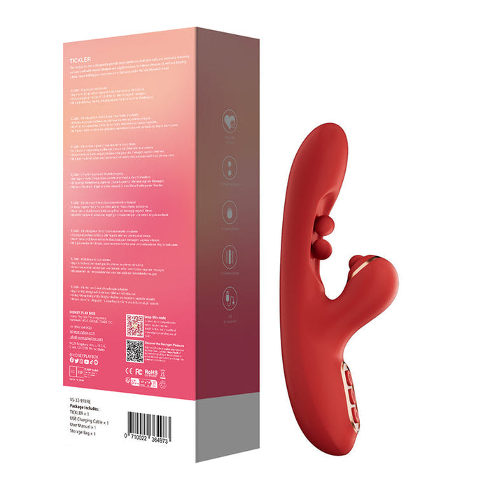 The Tickler Wiggling G-Spot Vibrator & Tapping Clitoral Stimulator - Red, with control buttons and a curved twin ball design, is shown beside its pink and purple packaging featuring icons. It’s designed for clitoral and G-spot pleasure.