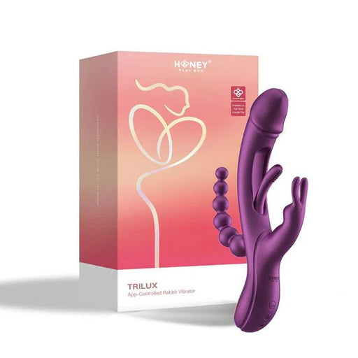 A sleek purple rabbit vibrator with anal beads, offering multiple vibrating modes for personalized pleasure. It's next to a pink and orange "Honey Play Box Trilux" box featuring an abstract couple drawing. Perfect for G-spot stimulation.