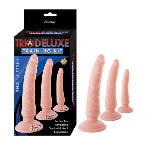 Image of a Trio Deluxe Advanced Anal Training Kit with 3 Realistic Dildos - Vanilla. This anal trainer set from Nasstoys includes three flesh-toned, curved silicone toys of varying sizes (4.5", 6.5", and 8.5"). Featuring secure suction cup bases, the packaging highlights "Three in One" and "Perfect for Advancing Vaginal & Anal Exploration".