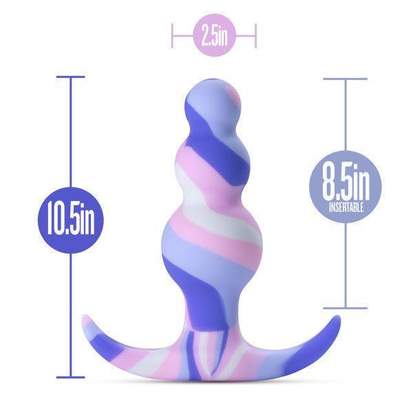Introducing the Twilight Beginner Purple and Pink Silicone Butt Plug by Blush — a beautifully striped, platinum-cured silicone butt plug with a wavy design and a flared base, ideal for those new to anal play. Standing 10.5 inches tall with an insertable length of 8.5 inches, this plug's widest part measures 2.5 inches and showcases vibrant shades of blue, purple, pink, and white.