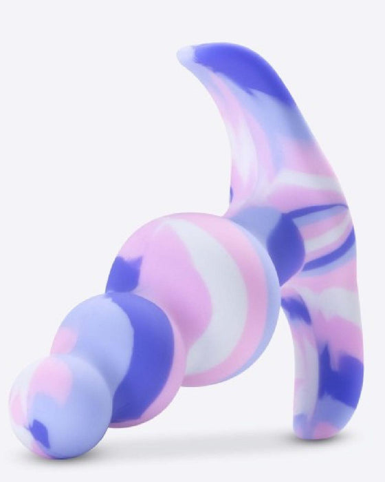 Introducing the Twilight Beginner Purple and Pink Silicone Butt Plug by Blush. This platinum-cured silicone toy showcases a vibrant abstract design with swirling patterns of purple, pink, and white. Perfect for anal beginners, it features three spherical segments, a curvy form, and a curved handle-like appendage. The base color is light blue highlighted with marbling of purple and pink.