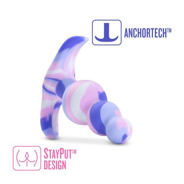 The Twilight Beginner Purple and Pink Silicone Butt Plug by Blush is crafted from platinum-cured silicone, featuring a unique corkscrew-like shape and gradient colors of pink, purple, and white. The image highlights "ANCHORTECH™" with an anchor symbol and "STAYPUT™ DESIGN" with a secure placement icon—ideal for anal beginners.