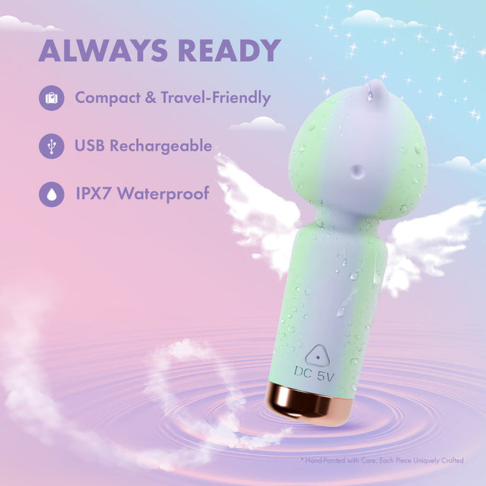 The Unicorn Dreams Mini Wand – Magical Pleasure Awaits features pastel colors, winged details, and body-safe silicone with water droplets. Compact, USB rechargeable, and IPX7 waterproof for enchanting relaxation against a dreamy sky backdrop.