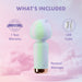 The Unicorn Dreams Mini Wand – Magical Pleasure Awaits, a pastel green and purple body-safe silicone massager, stands on pink with "1 Year Warranty," "USB Cable," and "Personal Massager" text against a dreamy sky.