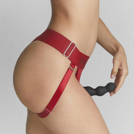 Unique Strap On Me Double Penetration Harnesses - Sideview of model wearing harness holding tip of dildo