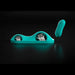 The VibePad Intense Ultra Powerful Ride On Hands-Free Humping Vibrator, shown in teal, sits on a charging dock with two slots and is paired with a matching handheld wireless remote, displayed against a black background.