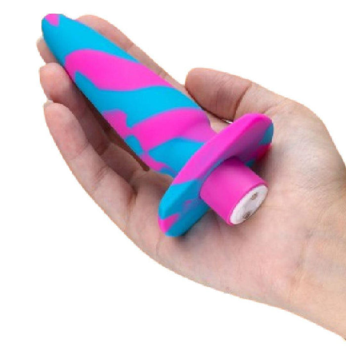 A hand is holding the Blush Vibrotize 10 Function Vibrating Silicone Butt Plug, a body-safe silicone sex toy featuring a blue and pink swirl design, a flared base, and a rounded tip—perfect for those seeking precise insertion.