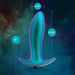 The Voyager Smooth Vibrating Butt Plug & Prostate Massager by Blush is an iridescent silicone anal toy designed in a plug shape. It boasts dimensions of 5 inches in height, with a width of 1.25 inches at the tip and expanding to 4.25 inches at its widest point. Set against a cosmic backdrop of swirling blue and green clouds, it presents an intriguing visual allure.