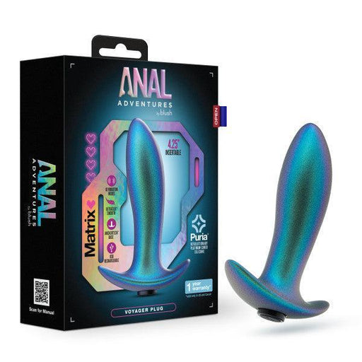 The image showcases a shimmering, metallic blue anal plug placed beside its box. The packaging is labeled "Anal Adventures Matrix" and prominently features product information and branding from Blush, highlighting it as the Voyager Smooth Vibrating Butt Plug & Prostate Massager made of silicone for an adventurous experience.