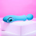The Wanderful Sucker Double Ended Wand + Clitoral Pulsation Vibrator in blue by Evolved Novelties is elegantly displayed on a white platform against a pink background. This silicone vibrator boasts a smooth, curved design with a circular opening and a rounded, textured end. It features controls along its body to enhance its clitoral air pulsation capabilities.