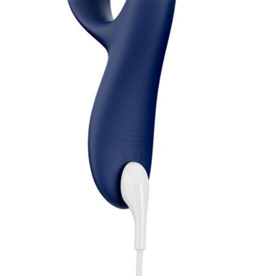 Close-up of the We-Vibe Nova 2 Powerful Flexible G-Spot Rabbit Vibrator in blue, with a white charging cable attached at the bottom. The device has a smooth, matte finish and features a hook-like handle at the top.