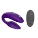 A purple We-Vibe Sync Remote and App Controlled Wearable Couples Vibrator is displayed next to a small black remote control featuring power, mode, and intensity buttons. Both items showcase simple, modern designs with a U-shaped vibrator that has textured ridges on one end. This versatile product from We-Vibe is perfect for creating intimate moments together.