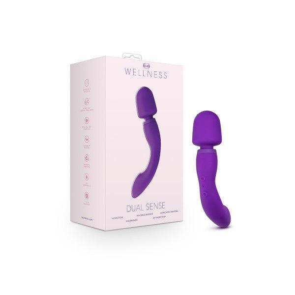 The Wellness Dual Sense Double Ended Ergonomic Waterproof Wand by Blush, a purple wellness-themed sex toy, features dual ends: one with a rounded, flattened tip and the other with a curved, ergonomic design. This G-spot vibrator highlights multiple vibration settings and flexible, body-safe material.