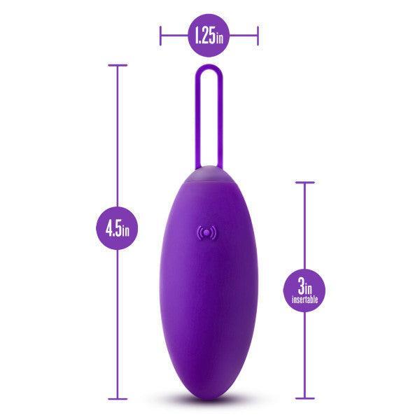 The Blush Wellness Imara Wearable Vibrating Egg with Remote in Purple features a 4.5-inch length, an insertable length of 3 inches, and a width of 1.25 inches. It includes a loop at the top and has a wireless signal icon on the front. This personal massager offers 10 different vibration modes and is equipped with a convenient wireless remote control for effortless operation.