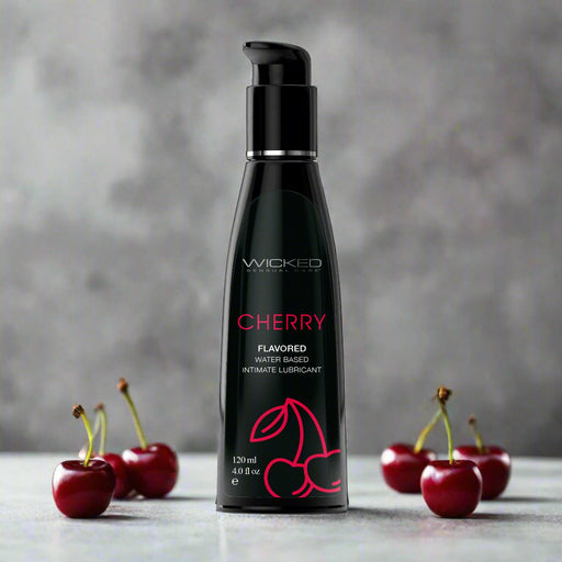 A sleek black bottle of Wicked Aqua Cherry Flavored Water Based Lubricant 4 oz by Wicked Lubes, featuring a cherry graphic and holding 120 ml (4.0 fl oz). This personal lubricant comes with a pump dispenser on top for easy use.