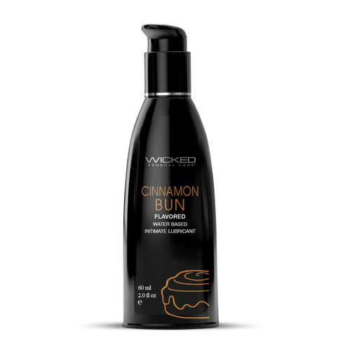 A black bottle with a pump top, containing Wicked Lubes' vegan Wicked Aqua Cinnamon Bun Flavored Water Based Lubricant. The bottle features product information in white and orange text and a simple illustration of a cinnamon bun near the bottom. It holds 60 ml (2.0 oz).