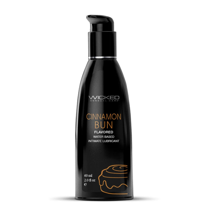 A black bottle with a pump top, containing Wicked Lubes' vegan Wicked Aqua Cinnamon Bun Flavored Water Based Lubricant. The bottle features product information in white and orange text and a simple illustration of a cinnamon bun near the bottom. It holds 60 ml (2.0 oz).
