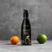 A black bottle of Wicked Lubes' Wicked Aqua Mango Flavored Water Based Lubricant, featuring a black pump top with yellow text and an image of a mango on the front. The bottle contains 60 ml (2.0 fl oz) of long-lasting mango lubricant.