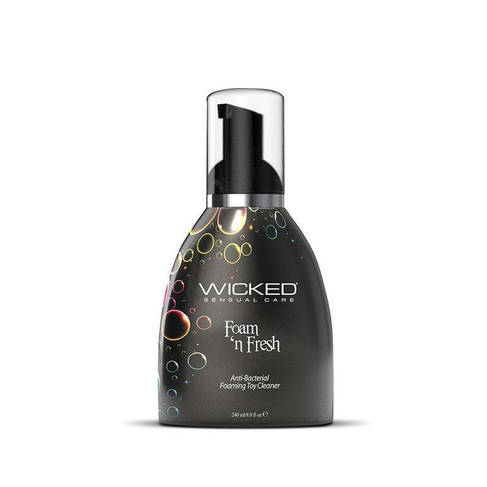 A bottle of Wicked Lubes' "Wicked Foam N Fresh Toy Cleaner 8oz." The dark container, decorated with vibrant bubbles, comes with a black pump dispenser. The label highlights its alcohol-free formula in white text and indicates a volume of 240ml/8 fl oz.