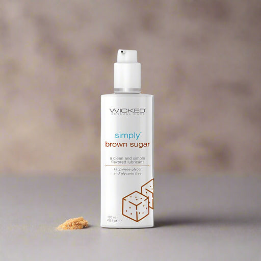 A 4 oz bottle of Wicked Lubes' "Wicked Simply Brown Sugar Flavored Water Based Lubricant" in white, featuring a white label with brown text that reads "a clean and simple flavored lubricant." This product is free from propylene glycol and glycerin, water-based, pH balanced, and comes with a pump dispenser.