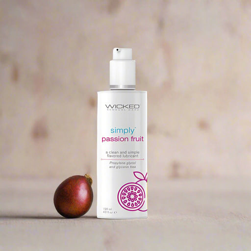 The "Wicked Simply Passion Fruit Flavored Water Based Lubricant 4 oz" by Wicked Lubes is presented in a white bottle adorned with a sketch of a passion fruit at the bottom, promoting its clean and simple passion fruit flavor. This water-based lubricant features a propylene glycol and glycerin-free, pH-balanced formula, and includes a convenient pump dispenser for easy use.