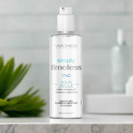 A bottle of Wicked Simply Timeless Jelle Water Based Lubricant - 4 oz, a water-based gel intimate lubricant by Wicked Lubes, enhanced with premium ingredients like olive leaf extract. The packaging showcases a clean, clinical design, and it's
