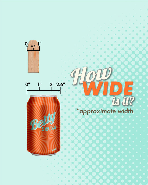 A whimsical comparison of widths: a wooden ruler with a cheerful face alongside a can of "betty soda" and the WOW Romp Piccolo First Time 5 Inch Silicone Dildo, inviting viewers to guess the approximate width of each.