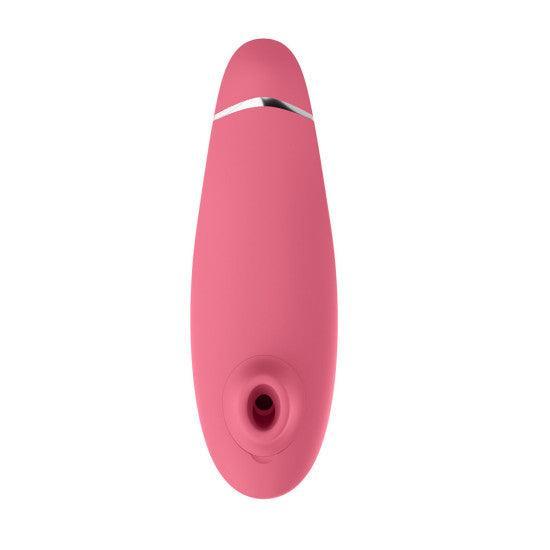 A sleek, raspberry-pink, tapered device with a small circular opening at one end and a smooth, matte finish. The design includes a metallic accent near the top. This Womanizer Premium 2 Pleasure Air Clitoral Stimulator by Womanizer is set against a white background.