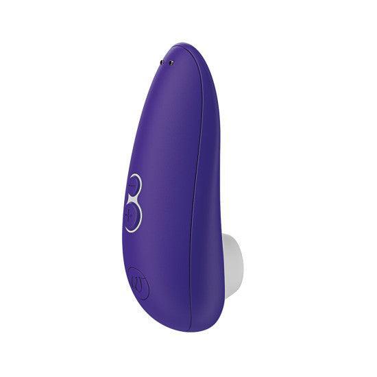 The Womanizer Starlet 3 Pleasure Air Clitoral Stimulator - Indigo by Womanizer is a sleek, purple electronic device with two small buttons and a charging port. It features USB rechargeable capabilities and includes a white, smooth attachment at the base designed for clitoral stimulation using advanced Pleasure Air Technology.