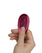 Ruby Glow Blush External Grinding Vibrator remote control held in hand
