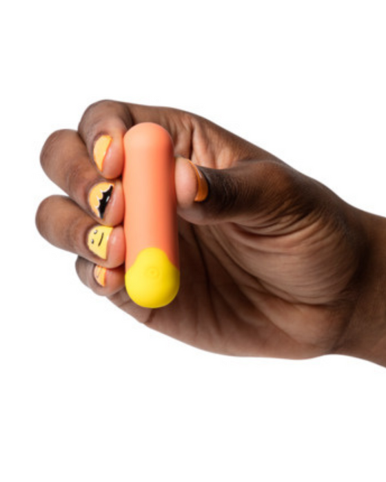 Romp Riot Bullet Vibrator being held by a hand on a white background